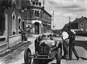 1932 French Grand Prix - Marcel Lehoux: Marcel Lehoux works on his Bugatti T54 after retiring