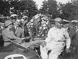 1933 Tourist Trophy - Tazio Nuvolari: Tazio Nuvolari, 1st position, on the podium and being congratulated by his wife