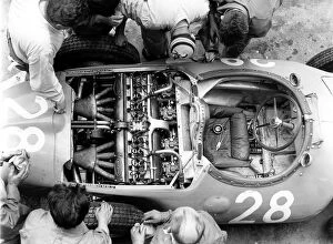 Aerial Gallery: 1956 French Grand Prix: Mechanics look at the straight 8 Bugatti 251 engine in Trintignants Bugatti Type 251 chassis