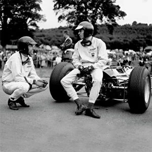 1960s F1 Collection: 1964 Belgian Grand Prix - Dan Gurney and Jim Clark: Jim Clark talks to Dan Gurney