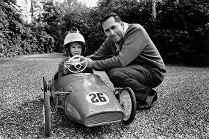 1966 British Grand Prix: Jack Brabham, 1st position, relaxes at his home in Woking, Surrey with son Gary, portrait