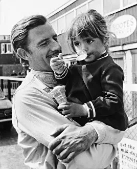 1968 BRDC International Trophy: Graham Hill, retired, with his 3 year old daughter Samantha, portrait