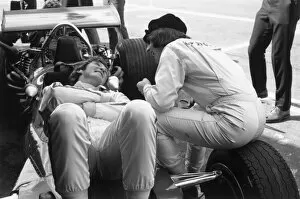 1969 Mexican Grand Prix: Jackie Stewart shares a joke with Jochen Rindt during practice, portrait