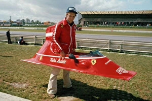 Images Dated 28th August 2012: 1974 Belgian Grand Prix - Niki Lauda: Niki Lauda playing with bodywork from his Ferrari 312B3