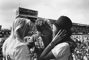 Images Dated 9th May 2013: 1976 South African Grand Prix: James Hunt, 2nd position, celebrates on the podium with some girls