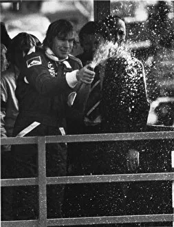 More images of Niki Lauda and James Hunt Collection: 1977 Race of Champions: James Hunt, 1st position, sprays Champagne on the podium, portrait