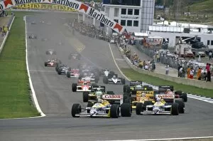 1980s F1 Gallery: 1987 Spanish Grand Prix: Nelson Piquet and teammate Nigel Mansell lead Ayrton Senna into Curva Expo at the start
