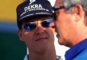1995 PORTUGESE GP. Michael Schumacher and Flavio Briatore. Photo: LAT