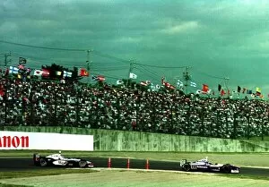 Images Dated 26th April 2021: 1997 JAPANESE GP. Heinz-Harald Frentzen leads Mika Hakkinen at Suzuka