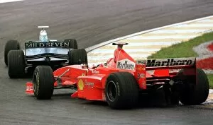 Images Dated 20th May 2021: 1998 BRAZILIAN GP. Alexander Wsrz, Benetton, leads the Ferrari of Michael Schumache