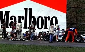 Images Dated 6th May 2021: 1998 BRAZILIAN GP. Photographers crowd round a stranded McLaren out on the track for