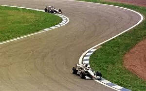 1998 SPANISH GP. Mika Hakkinen leads team mate David Coulthard