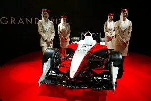 Images Dated 1st April 2004: A1 Grand Prix Launch: Emirates girls with the Lola A1 Grand Prix car