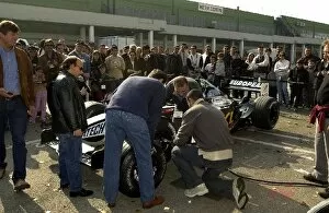 Images Dated 27th October 2002: Annual Minardi Day Celebration: Minardi fans take part in a wheel changing challenge