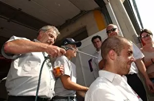 Images Dated 10th August 2003: Dr. Markus Schmidt (GER), Medical Doctor Mercedes-Benz blows away the hairs after one of the team