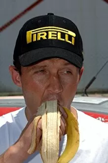 Images Dated 25th June 2005: FIA World Rally Championship: Gigi Galli, Mitsubishi, refuels with a banana at the service park