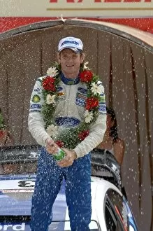 Images Dated 15th October 2006: FIA World Rally Championship: Marcus Gronholm, Ford, sprays the winners champagne on the podium in