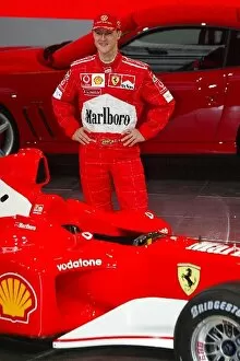 Images Dated 6th February 2002: Formula One Launch: 2001 F1 World Champion Michael Schumacher stands alongside the Ferrari F2002