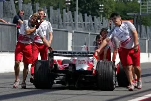 Formula One Testing: The car of Jarno Trulli Toyota is pushed back down the pitlane