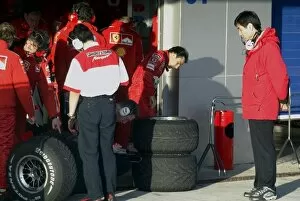 Engineer Collection: Formula One Testing: Ferrari mechanics and Brigestone engineers check on the cars intermediate tyres