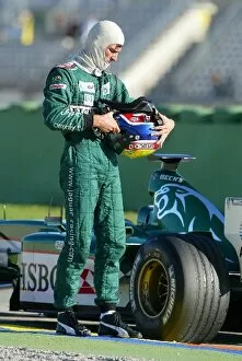 Images Dated 26th November 2003: Formula One Testing: Mark Webber inspects his Jaguar Cosworth R4