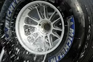 Images Dated 8th January 2004: Formula One Testing: A McLaren mechanic washes the used Michelins