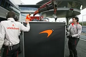 Images Dated 5th March 2009: Formula One Testing: McLaren use screens to block their car from view after it returns from a