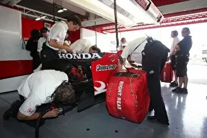Images Dated 30th April 2007: Formula One Testing: Mechanics start the car of Takuma Sato Super Aguri F1 Team SA07 in the garage