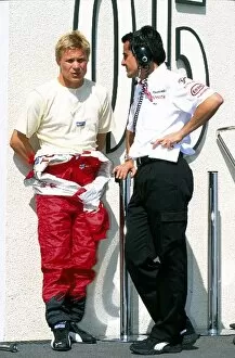 Images Dated 20th May 2002: Formula One Testing: Mika Salo talks with Ange Pasquali Toyota Motorsport Team Manager