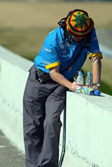 Images Dated 11th February 2004: Formula One Testing: A Renault engineer takes some times out on the circuit with some unusual head