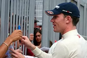 Images Dated 25th August 2005: Formula One Testing: Robert Doornbos Minardi Cosworth signs autographs for the fans