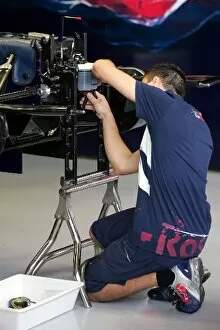 Images Dated 30th May 2006: Formula One Testing: A Scuderia Torro Rosso mechanics works on the teams car for tomorrows testing