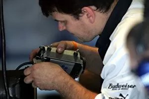 Images Dated 24th August 2005: Formula One Testing: A Williams mechanic dismantles the data recorder that was attached to the car