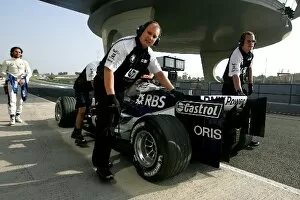Images Dated 14th July 2005: Formula One Testing: Williams mechanics push the V8 powered Williams back down the pit lane