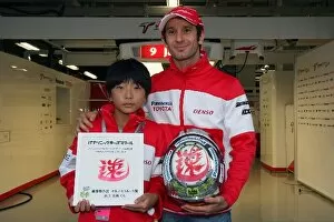 Images Dated 3rd October 2009: Formula One World Championship: 11-year old Mitsuki Inoue and the helmet he has designed for Jarno