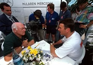 Formula One World Championship: BBC TV Commentator Murray Walker talks with Nigel Mansell who finished tenth in his