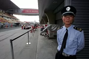 Images Dated 17th October 2008: Formula One World Championship: Chinese police man in the pitlane