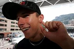 Images Dated 18th May 2005: Formula One World Championship: Christian Klien shows off his earing in the Red Bull Racing Energy