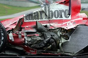 Images Dated 23rd October 2004: Formula One World Championship: The damaged car of Michael Schumacher Ferrari F2004 is loaded onto
