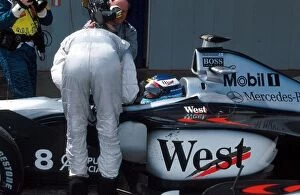 Formula One World Championship: David Coulthard McLaren who finished 2nd, chats to race winner Mika Hakkinen McLaren Mercedes MP4/13 in parc ferme
