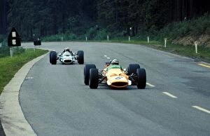 Formula One World Championship: Denny Hulme McLaren Cosworth M7A, leads Jackie Stewart Matra Cosworth MS10