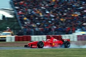 Brakes Collection: Formula One World Championship: Eddie Irvine Ferrari F300 locks up on his way to 3rd place