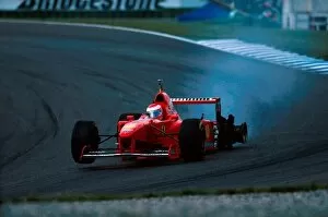 Formula One World Championship: Eddie Irvine Ferrari F310B retires with a puncture