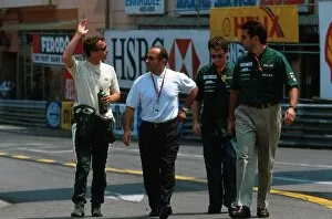 Formula One World Championship: Eddie Irvine Jaguar Cosworth R1 waves to the crowd as he walks to the pits with Jac