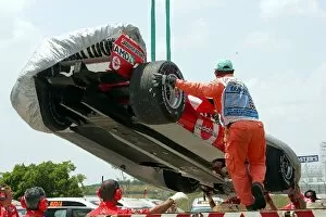 Formula One World Championship: The Ferrari F2004M of Rubens Barrichello is returned to the pits on a truck after he