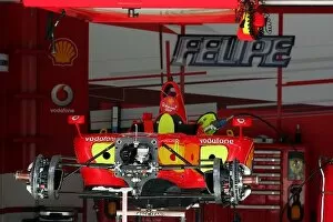 Images Dated 8th March 2006: Formula One World Championship: Ferrari F248 F1 in the pits stripped down