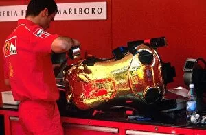 Images Dated 27th May 2002: Formula One World Championship: A Ferrari mechanic makes adjustments to one of their drivers seats