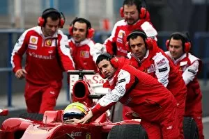 Formula One World Championship: Ferrari mechanics run to the aid of Felipe Massa Ferrari F10 as he stops at the pit