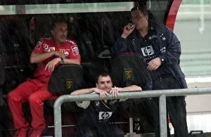 Images Dated 21st March 2003: Formula One World Championship: Ferrari and Williams engineers shelter from the rain