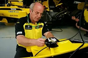 Formula One World Championship: George Holroyd from Geographics stickers the Jordan EJ15 car with sponsor logos